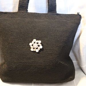 The Sak black shoulder bag with clear sparkle brooch.